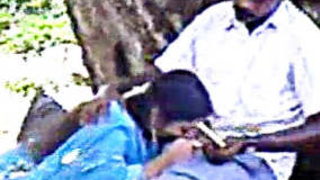 A Tamil middle-aged man coerces a lovely young woman into performing oral sex on him in a public park
