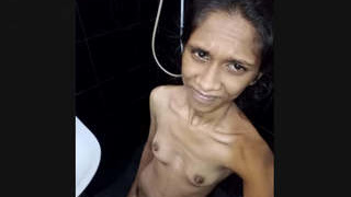 A thin Sri Lankan girl with small breasts bathes
