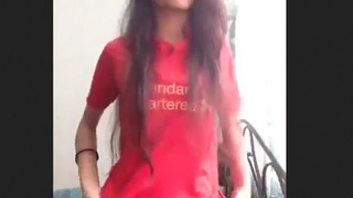 A stunning young woman undresses and displays her physique