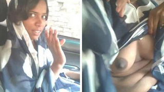 A South Asian woman reveals her breasts and performs oral sex on a man in a vehicle
