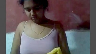 A village girl from India is fondled while bathing