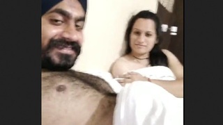 Passionate couple engages in intimate acts in a hotel room