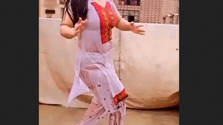 A seductive woman performs a rain dance and displays her underwear