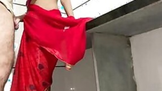 Desi slut in a red sari pleases a guy in her kitchen