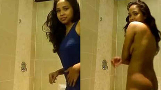 A young Indian woman undresses in her bathroom and gets captured on camera