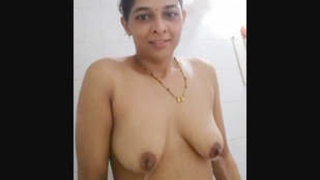 Elderly woman's lovely bathing session with a hint of nudity