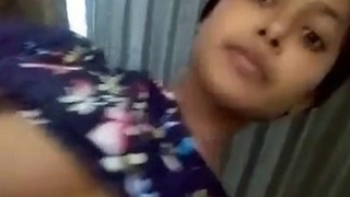 A cute Desi girl reveals her big breasts and moist pussy