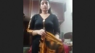 Watch a busty wife strip down in this extended video