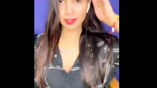 A pretty Indian girl displays her breasts during a real-time performance on Tango