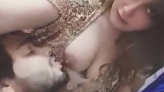 A stunning girl's breast is orally pleasured by her male partner
