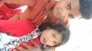 Indian couple kisses and fondle breasts in open-air setting with Hindi soundtrack