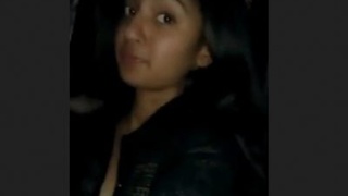 A charming South Asian blonde woman reveals her cleavage by unbuttoning her dress