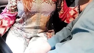 A genuine Indian girlfriend's milky breasts are pleasured in a car with Hindi commentary