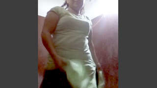 Indian village woman undresses and pleasures herself in the tub