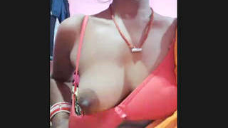 An Indian homemaker proudly displays her large breasts