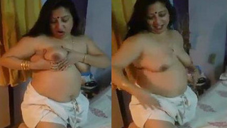 An Indian housewife prepares for a sexual encounter while engaging in vulgar conversation in Bengali