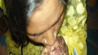 Indian woman in yellow saree gives oral pleasure to a well-endowed man